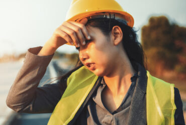 Construction worker woman wiping sweat